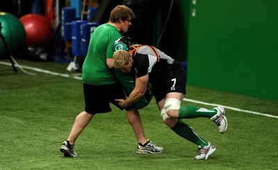 22.02.10 - Wales Rugby Training - Bradley Davies tackles Rhys Gills tackle bag during training. 