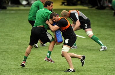 22.02.10 - Wales Rugby Training - Deiniol Jones tackles Sam Warburtons tackle bag during training. 