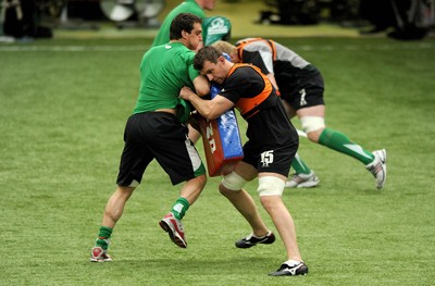 22.02.10 - Wales Rugby Training - Deiniol Jones tackles Sam Warburtons tackle bag during training. 
