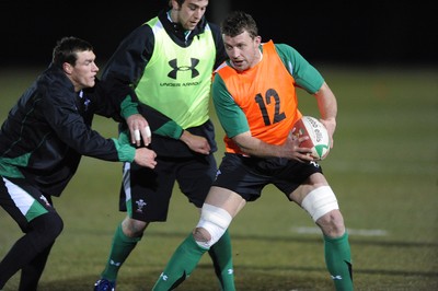 22.02.10 - Wales Rugby Training - Deiniol Jones is tackled by Tom James and Ryan Jones during a night training session in preparation for Wales Friday night match with France. 