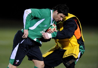 22.02.10 - Wales Rugby Training - Mike Phillips is tackled by Eifion Lewis-Roberts during a night training session in preparation for Wales Friday night match with France. 