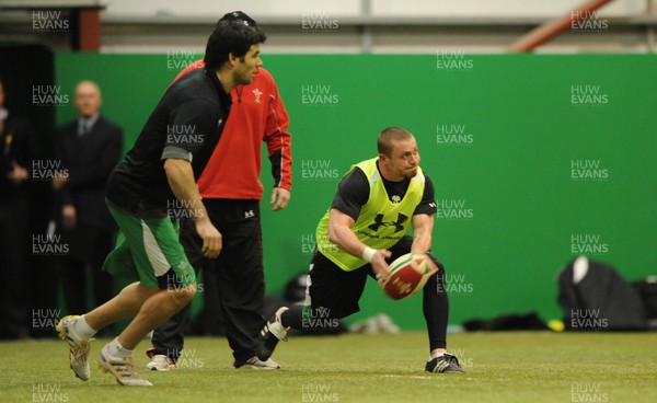 22.02.10 - Wales Rugby Training - Richie Rees gets the ball away as Mike Phillips follows during training. 