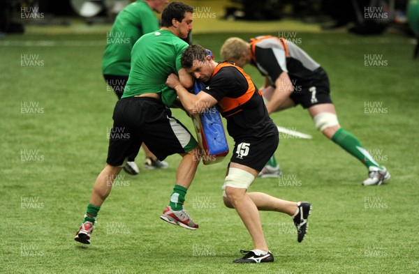 22.02.10 - Wales Rugby Training - Deiniol Jones tackles Sam Warburtons tackle bag during training. 
