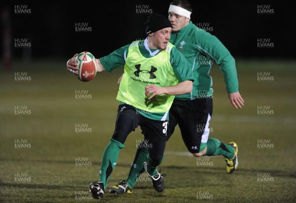 22.02.10 - Wales Rugby Training - Richie Rees is tackled by Paul James during a night training session in preparation for Wales Friday night match with France. 