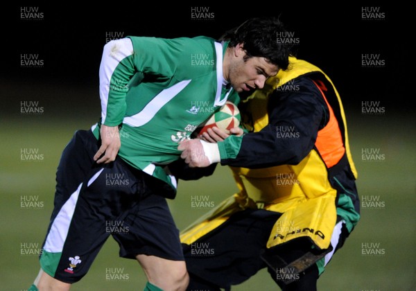 22.02.10 - Wales Rugby Training - Mike Phillips is tackled by Eifion Lewis-Roberts during a night training session in preparation for Wales Friday night match with France. 