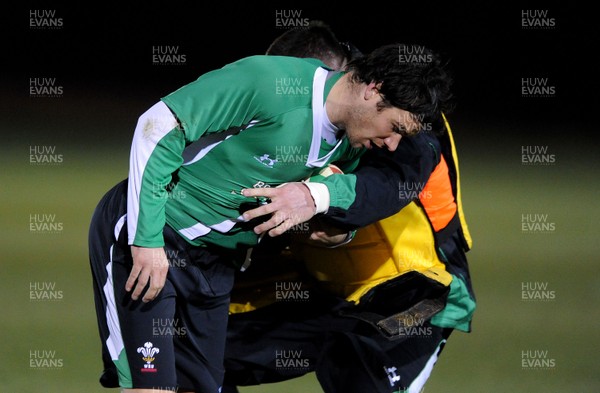 22.02.10 - Wales Rugby Training - Mike Phillips is tackled by Eifion Lewis-Roberts during a night training session in preparation for Wales Friday night match with France. 