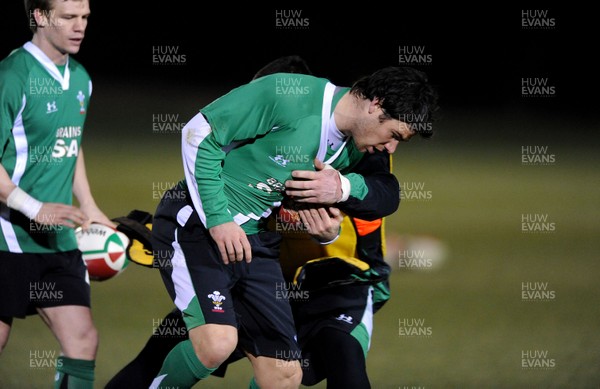 22.02.10 - Wales Rugby Training - Mike Phillips is tackled by Eifion Lewis-Roberts during a night training session in preparation for Wales Friday night match with France. 