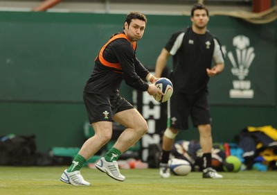 23.02.09 - Wales Rugby Training - Stephen Jones makes a pass as Mike Phillips looks on during training. 