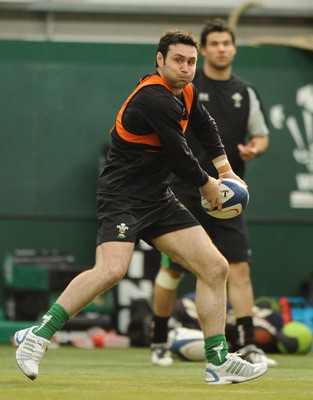 23.02.09 - Wales Rugby Training - Stephen Jones makes a pass as Mike Phillips looks on during training. 