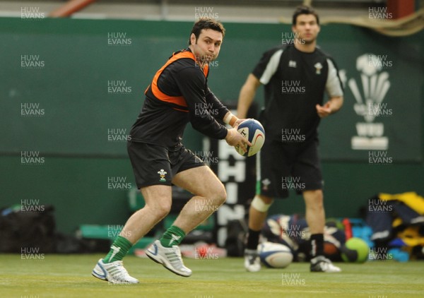 23.02.09 - Wales Rugby Training - Stephen Jones makes a pass as Mike Phillips looks on during training. 