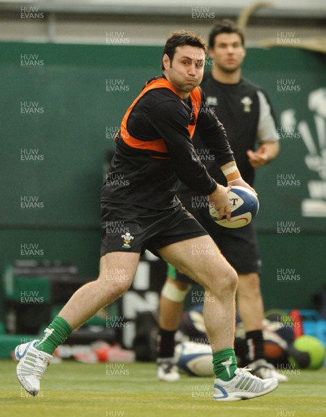 23.02.09 - Wales Rugby Training - Stephen Jones makes a pass as Mike Phillips looks on during training. 