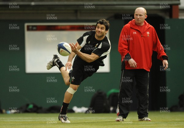 23.02.09 - Wales Rugby Training - Mike Phillips makes a pass as kicking coach, Neil Jenkins looks on during training. 