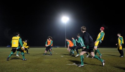 24.02.10 - Wales Rugby Training - Adam Jones makes a pass during a night training session in preparation for Wales Friday night match against France. 
