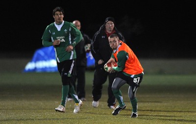 24.02.10 - Wales Rugby Training - Richie Rees gets the ball away as Mike Phillips(L) follows during a night training session in preparation for Wales Friday night match against France. 