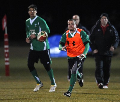 24.02.10 - Wales Rugby Training - Richie Rees gets the ball away as Mike Phillips(L) follows during a night training session in preparation for Wales Friday night match against France. 