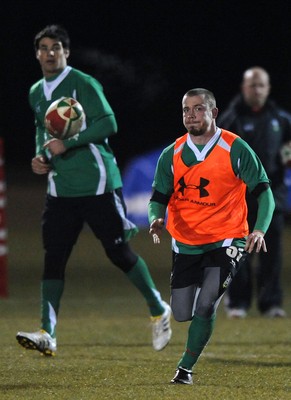 24.02.10 - Wales Rugby Training - Richie Rees gets the ball away as Mike Phillips(L) follows during a night training session in preparation for Wales Friday night match against France. 