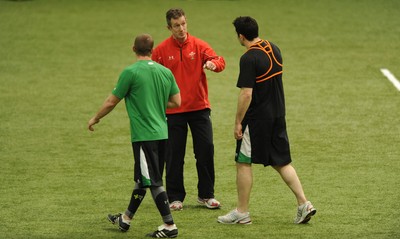 24.02.10 - Wales Rugby Training - Richie Rees and Stephen Jones talk to backs coach Rob Howley during training. 