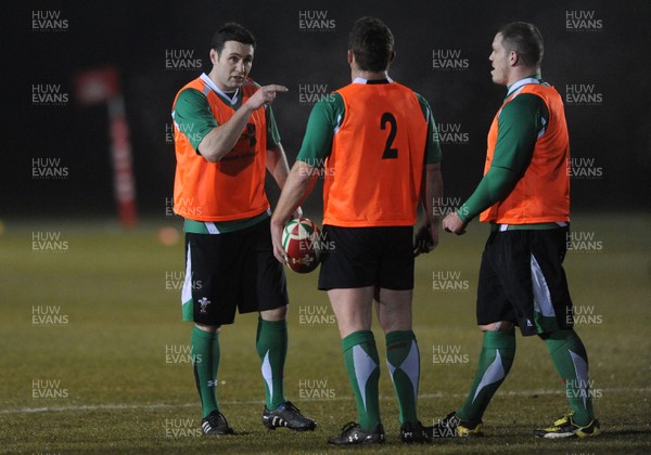 24.02.10 - Wales Rugby Training - Stephen Jones talks toHuw Bennett(c) and Paul James(r) during a night training session in preparation for Wales Friday night match against France. 