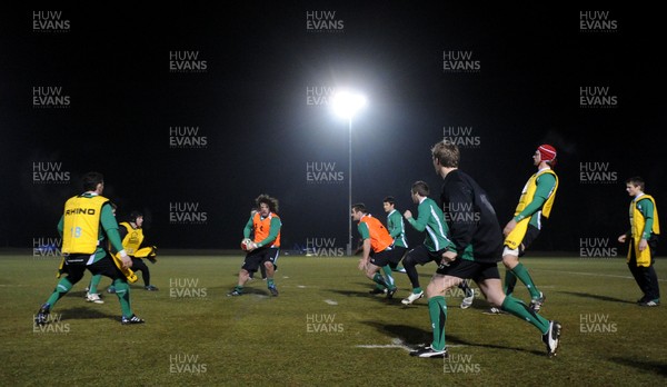 24.02.10 - Wales Rugby Training - Adam Jones makes a pass during a night training session in preparation for Wales Friday night match against France. 