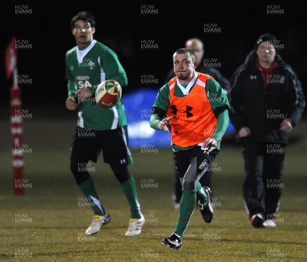 24.02.10 - Wales Rugby Training - Richie Rees gets the ball away as Mike Phillips(L) follows during a night training session in preparation for Wales Friday night match against France. 