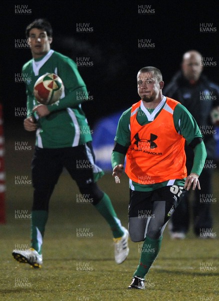 24.02.10 - Wales Rugby Training - Richie Rees gets the ball away as Mike Phillips(L) follows during a night training session in preparation for Wales Friday night match against France. 