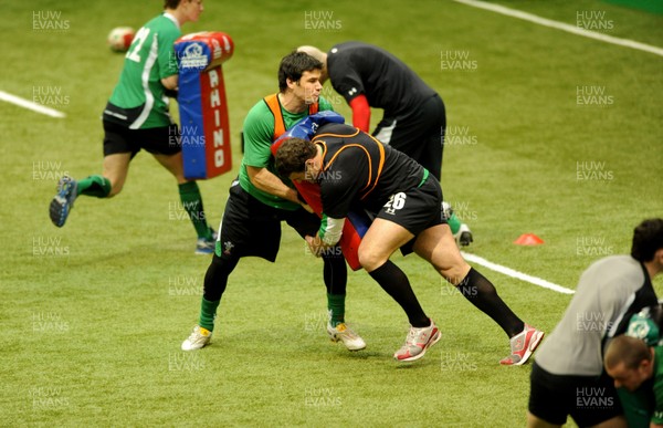 24.02.10 - Wales Rugby Training - Jamie Roberts hits Mike Phillips' tackle bag during training. 