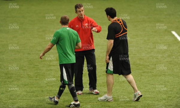 24.02.10 - Wales Rugby Training - Richie Rees and Stephen Jones talk to backs coach Rob Howley during training. 