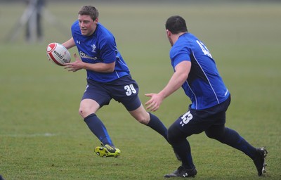25.01.11 - Wales Rugby Training - Rhys Priestland takes on Ryan Bevington during training. 