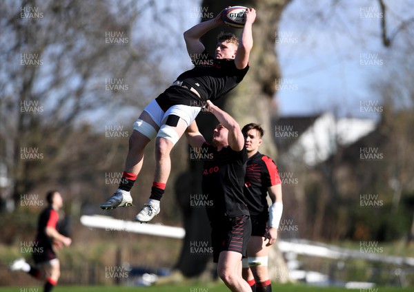250222 - Wales Rugby Training - Jac Morgan is lifted by Dewi Lake during training
