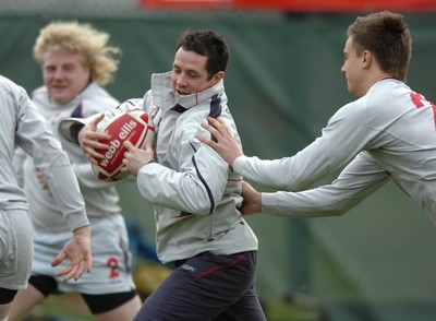 260107 - Wales Rugby Training - Gareth Cooper is caught by Chris Czekaj during training 