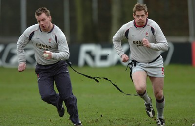 260107 - Wales Rugby Training - Rhys Thomas(R) and Matthew Rees go through a move during training 
