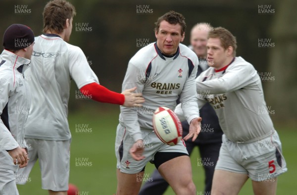 260107 - Wales Rugby Training - Scott Morgan is caught by Rhys Thomas(R) and Gavin Evans during training 