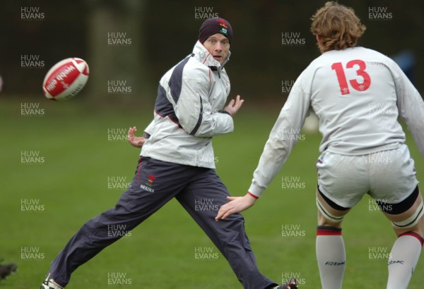 260107 - Wales Rugby Training - Kevin Morgan offloads as Alun Wyn Jones closes in during training 
