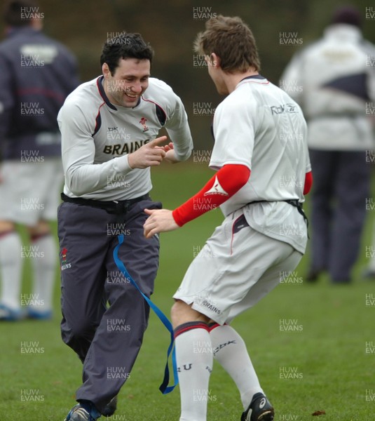 260107 - Wales Rugby Training - Gavin Evans(R) and Stephen Jones go through a move during training 