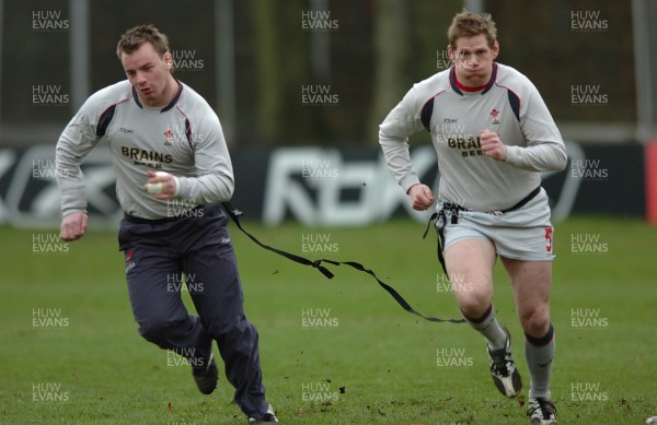 260107 - Wales Rugby Training - Rhys Thomas(R) and Matthew Rees go through a move during training 