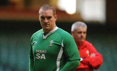 27.11.09 - Wales Rugby Training - Gethin Jenkins during training as head coach Warren Gatland looks on. 