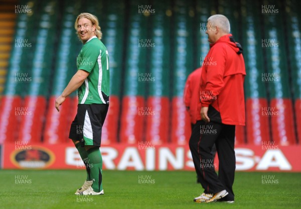 27.11.09 - Wales Rugby Training - Andy Powell during training as head coach Warren Gatland looks on. 