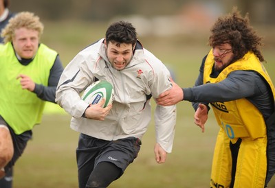 28.02.08 - Wales Rugby Training - Stephen Jones gets past Adam Jones(R) during training 