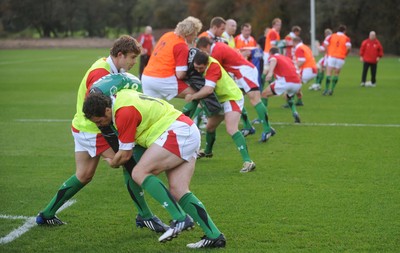 28.10.09 - Wales Rugby Training - Mark Jones hits Leigh Halfpenny's tackle bag during training. 