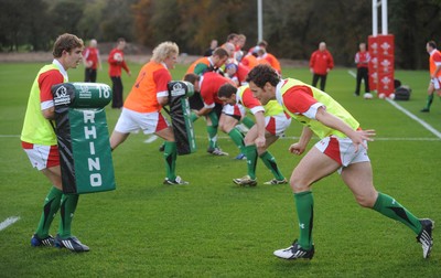 28.10.09 - Wales Rugby Training - Mark Jones hits Leigh Halfpenny's tackle bag during training. 