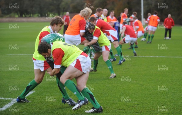 28.10.09 - Wales Rugby Training - Mark Jones hits Leigh Halfpenny's tackle bag during training. 