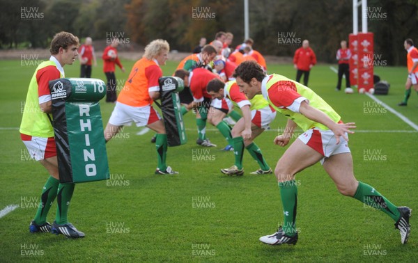 28.10.09 - Wales Rugby Training - Mark Jones hits Leigh Halfpenny's tackle bag during training. 