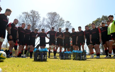 300622 - Wales Rugby Training - Will Rowlands, Dillon Lewis, Tommy Reffell, Liam Williams, Nick Tompkins, Kieran Hardy, Adam Beard, Dan Biggar, Talupe Faletau, Ryan Elias, Josh Adams, Gareth Thomas, Rhys Carre, Tomas Francis, Taine Basham, Johnny Williams huddle during training