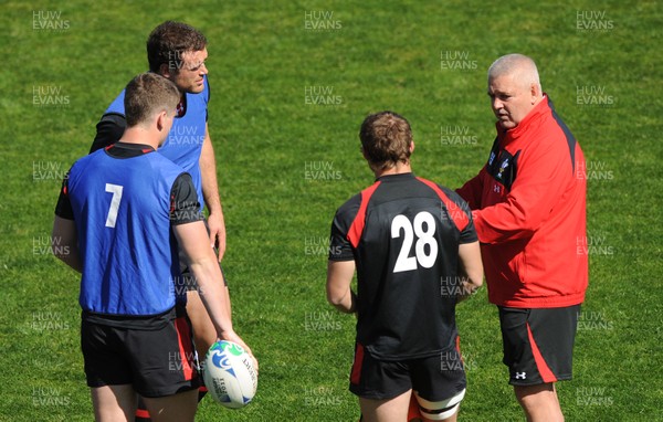 30.09.11 - Wales Rugby Training - Head coach Warren Gatland talks to Jamie Roberts, Scott Williams and Leigh Halfpenny during training. 