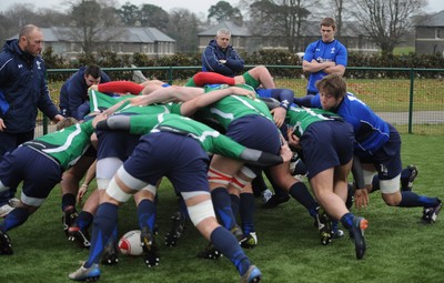 31.01.11 - Wales Rugby Training - Wales players scrummage with Wales under 20 players as head coach Warren Gatland looks on during training. 