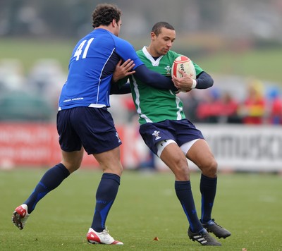 31.01.11 - Wales Rugby Training - Eli Walker of Wales under 20 is tackled by Jamie Roberts during training. 