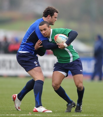 31.01.11 - Wales Rugby Training - Eli Walker of Wales under 20 is tackled by Jamie Roberts during training. 