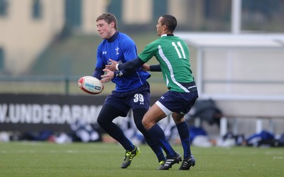 31.01.11 - Wales Rugby Training - Rhys Priestland is tackled by Eli Walker of Wales under 20s during training. 