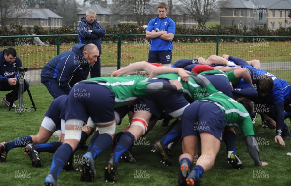 31.01.11 - Wales Rugby Training - Wales players scrummage with Wales under 20 players as head coach Warren Gatland looks on during training. 