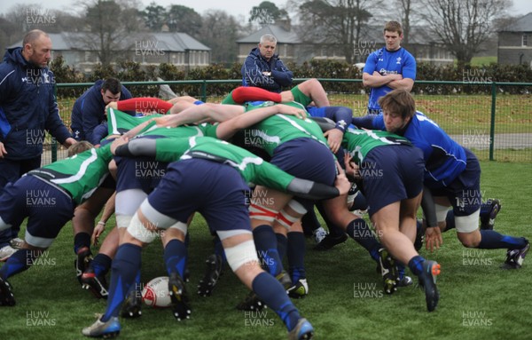 31.01.11 - Wales Rugby Training - Wales players scrummage with Wales under 20 players as head coach Warren Gatland looks on during training. 